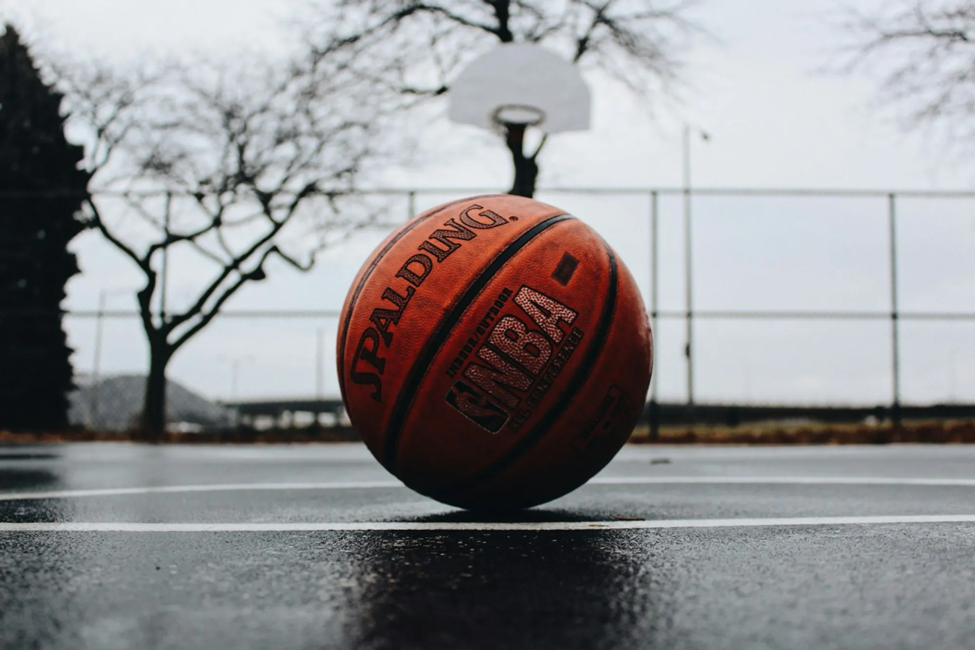 A basketball resting on an outdoor court