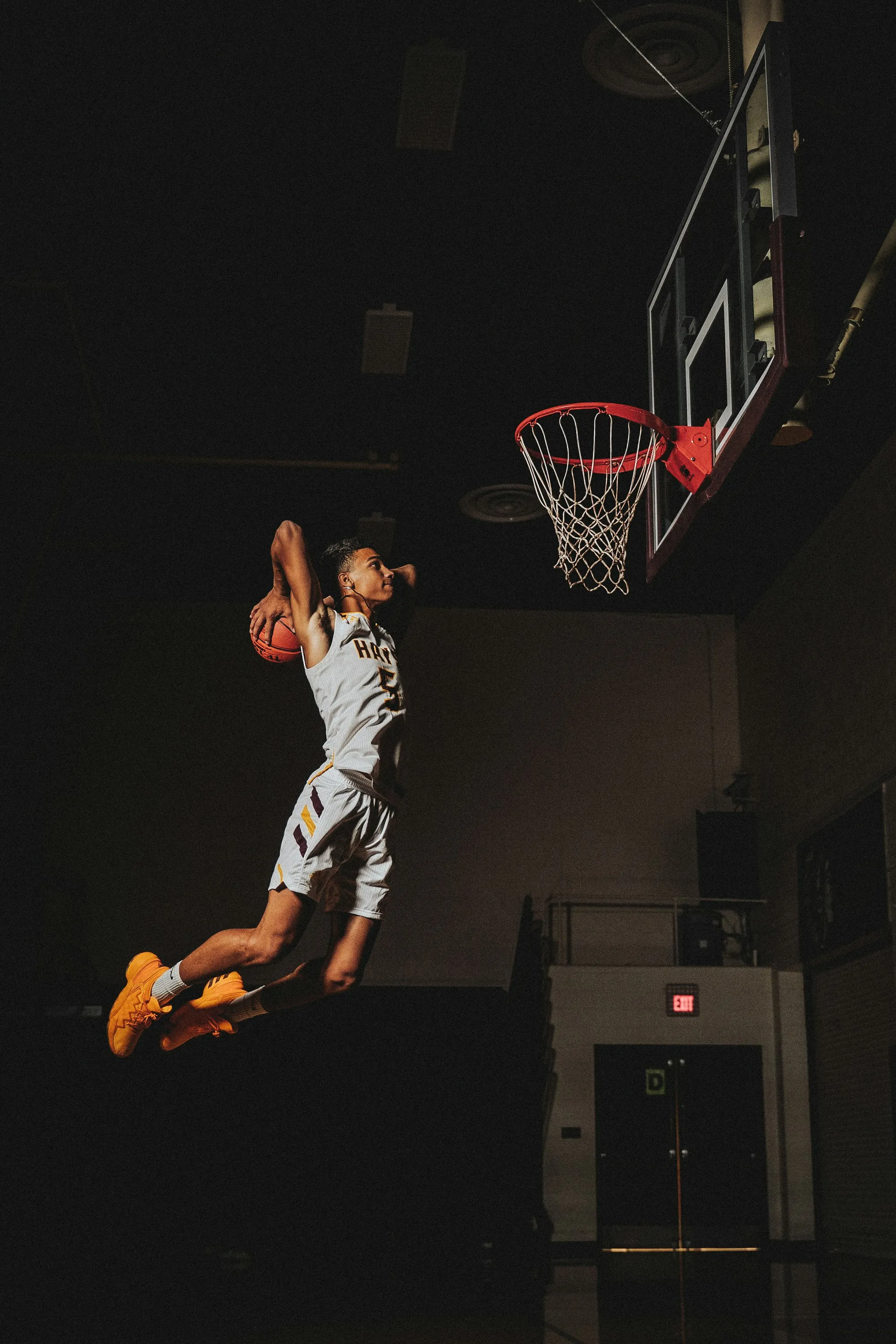 A basketball player finishing at the rim